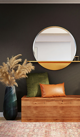 Banc en bois avec coussins, miroir rond et vase de pampas.